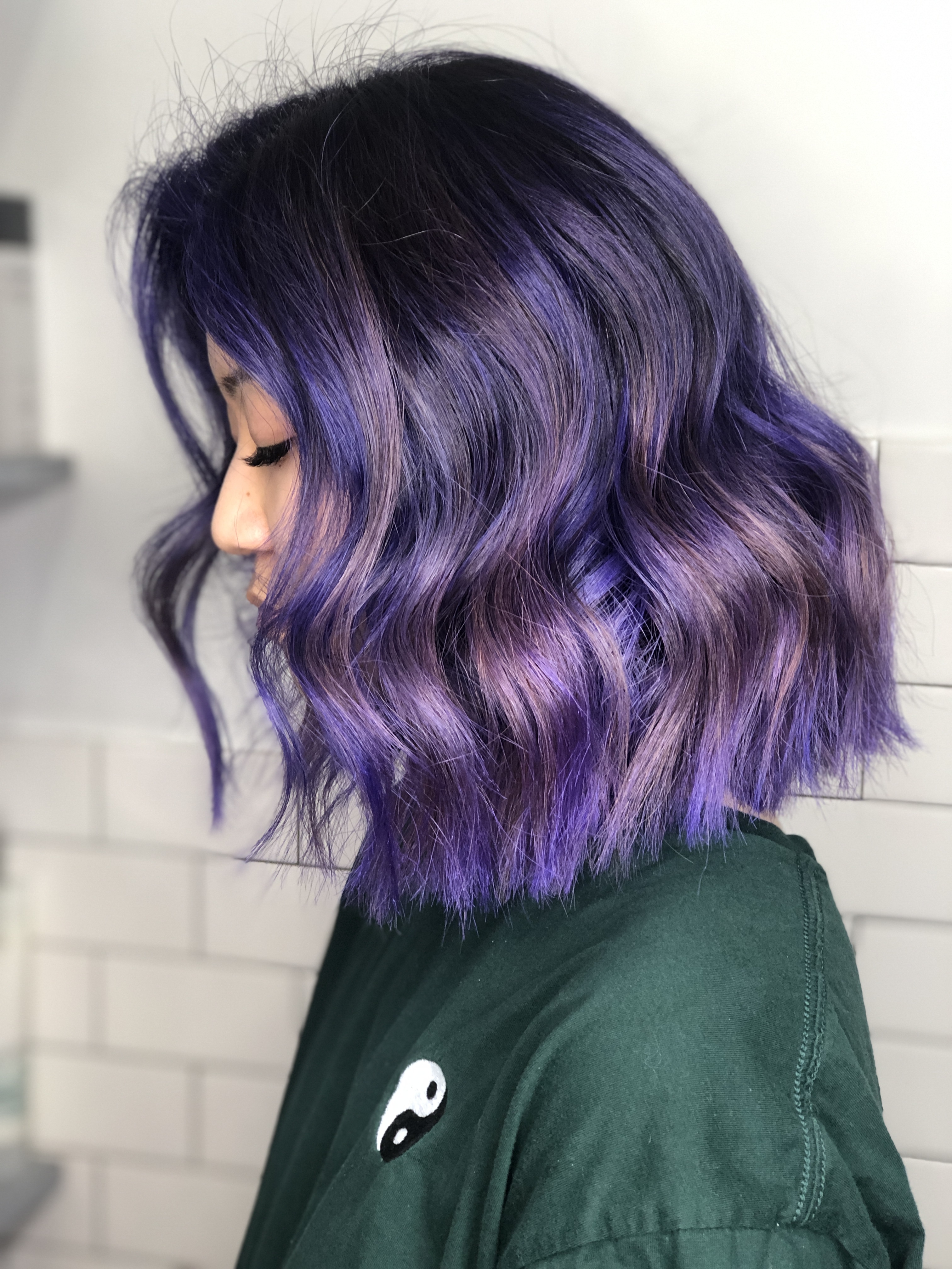 A client with wavy purple hair.