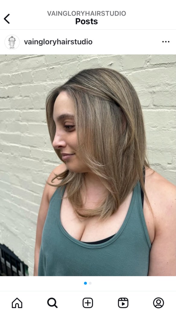 An Instagram post showcasing a smiling client with a new mid-length haircut