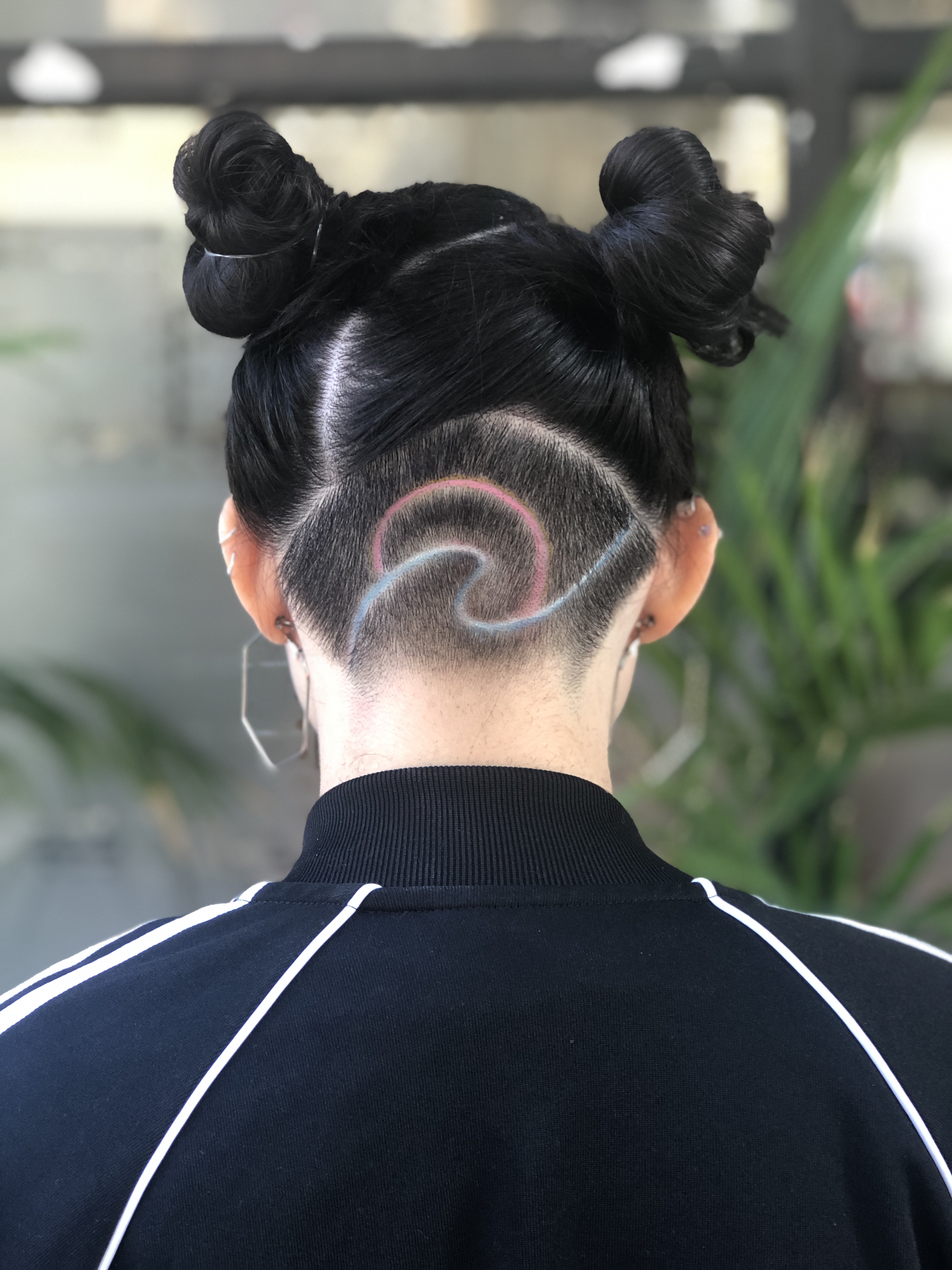 A client with a design shaved at the back of her haircut