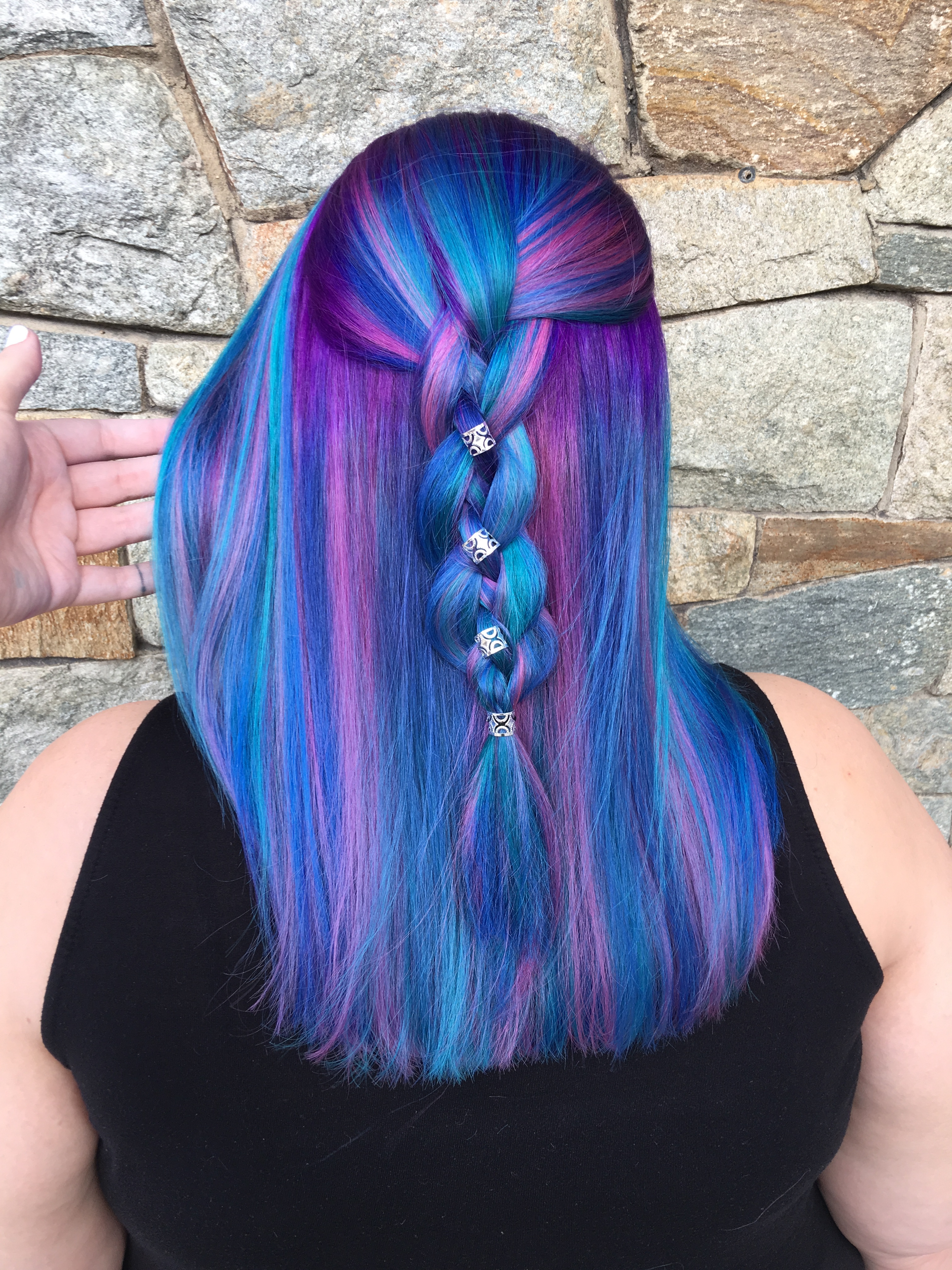 Long hair streaked in purple and shades of blue