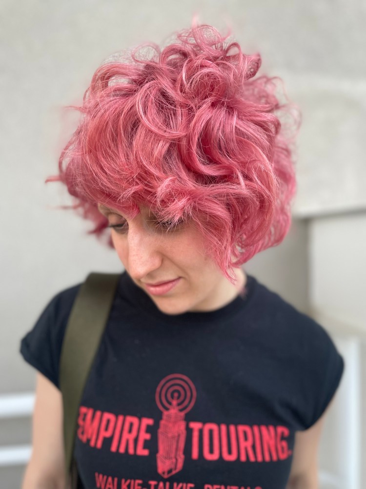 A client with curly pink hair